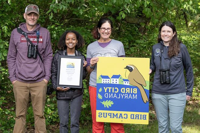 Washington College staff pose with the Bird Campus plaque and program coordinator from the Maryland Bird Conservation Partnership.